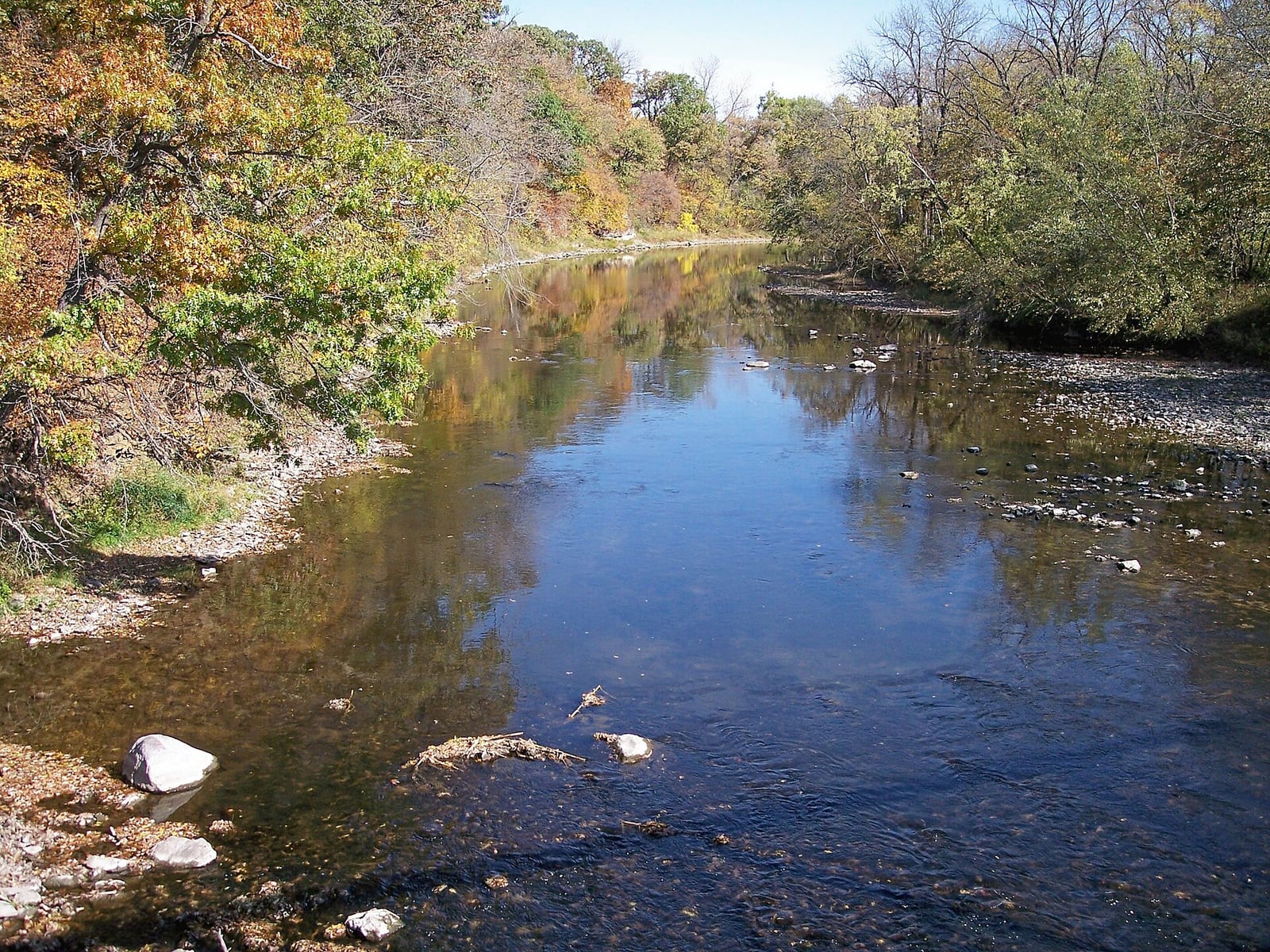 The Boone River bends below a wooded bank near Albright canoe access in Hamilton County, Iowa.