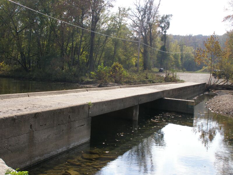 The Buffalo River flows under the low-water bridge at Ponca with forested Ozark hills in the background.