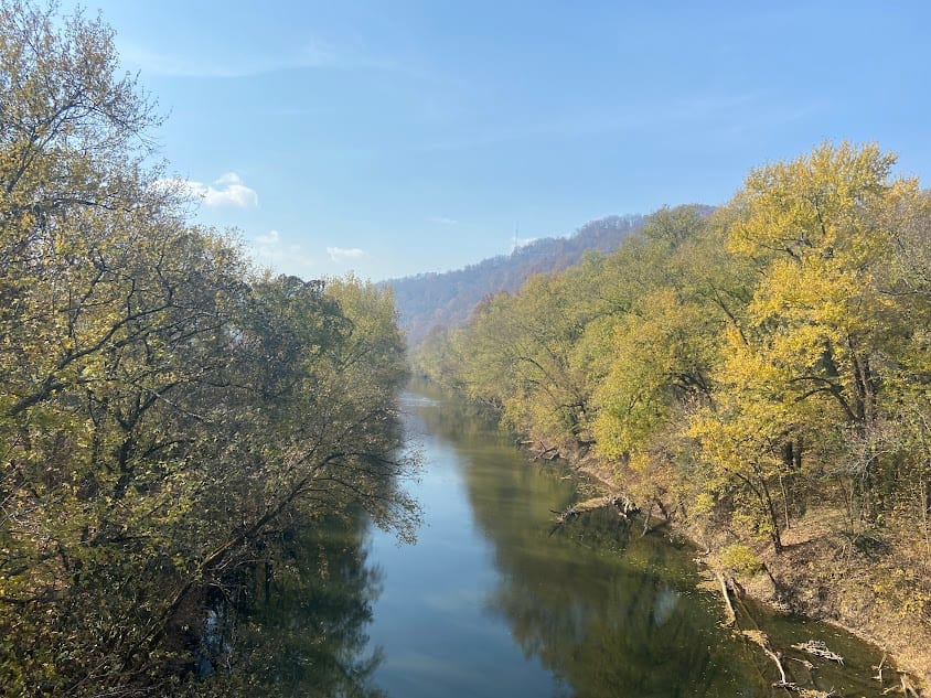 The Levisa Fork flows past Pikeville, Kentucky, with a broad river channel and wooded slopes nearby.