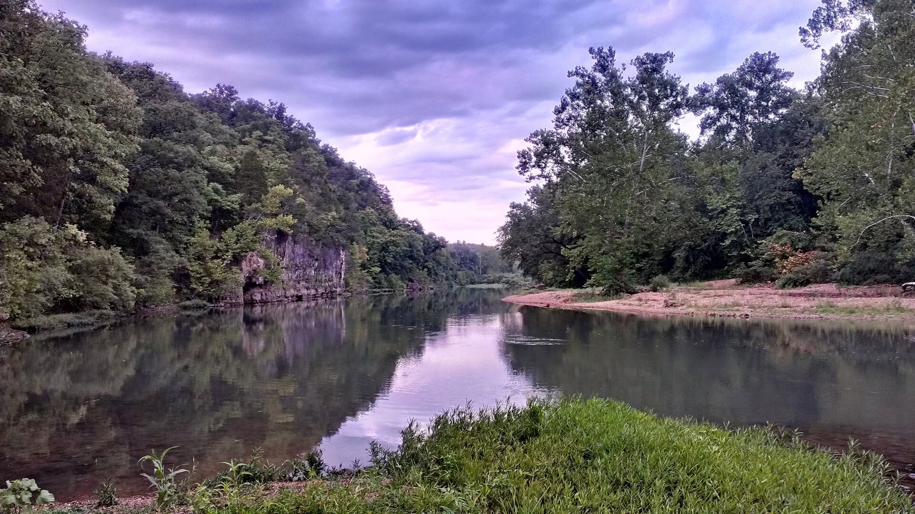 The Meramec River runs past Onondaga Cave State Park with wooded banks and low gravel edges.