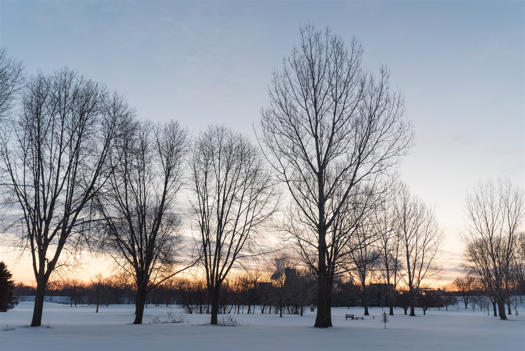 A winter view of Land of Memories Park in Mankato with the broad river corridor and snow-covered trees.