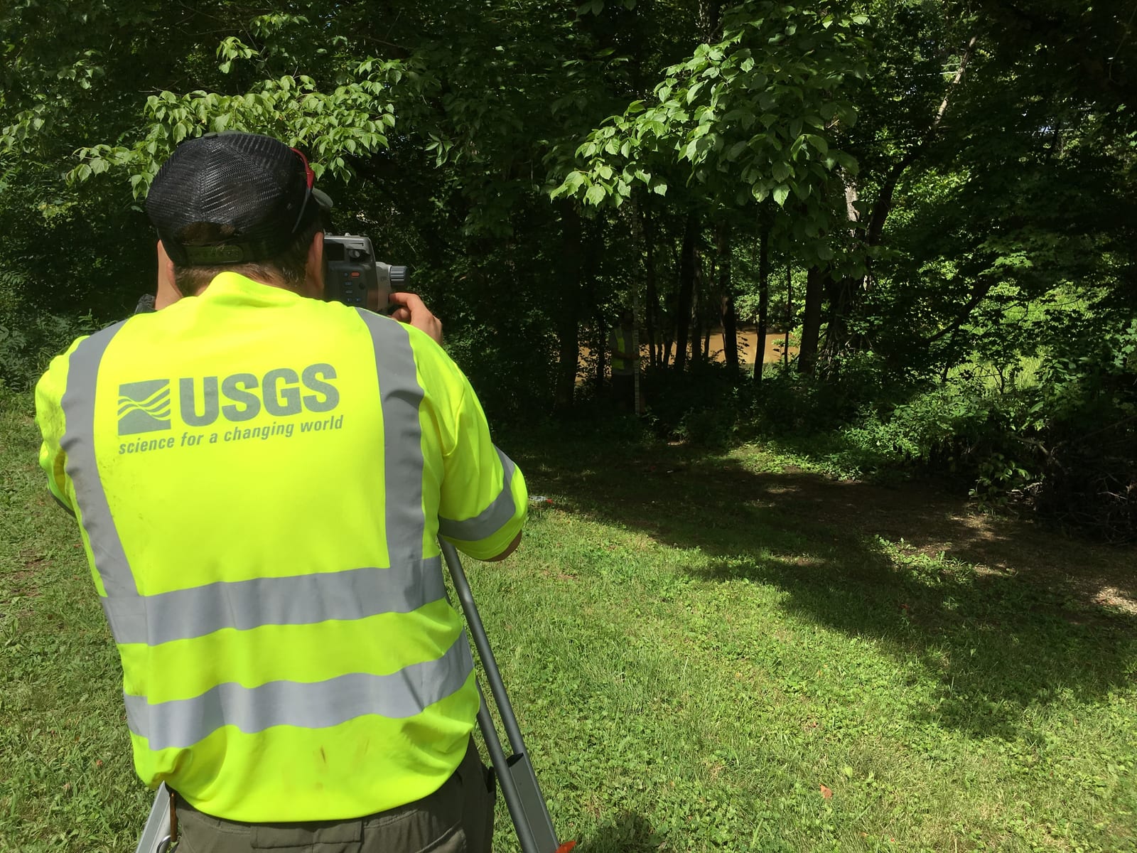 A USGS crew works along Slate Creek at Owingsville, Kentucky, with shallow water and wooded banks behind them.