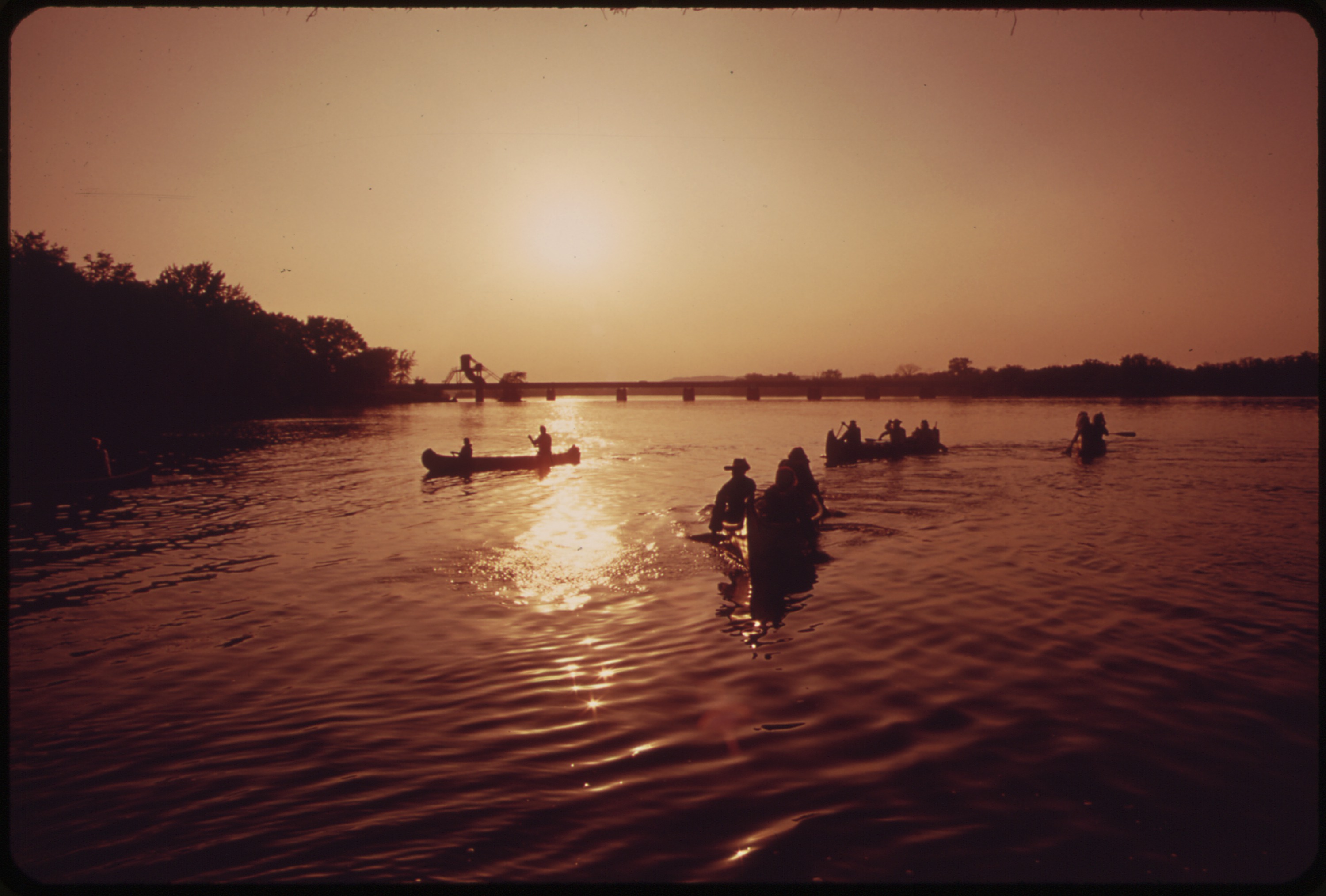 Canoes and paddlers reach Muscoda on the Wisconsin River during a 1973 historical river trip.